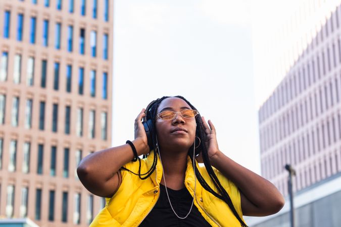 Glad female listening to music in city
