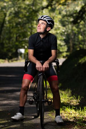 Professional cyclist riding bike in park