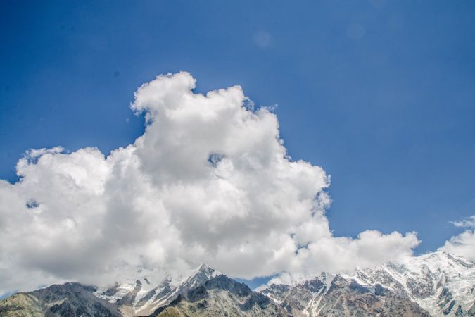Fluffy clouds in blue sky over mountains in Pakistan national park