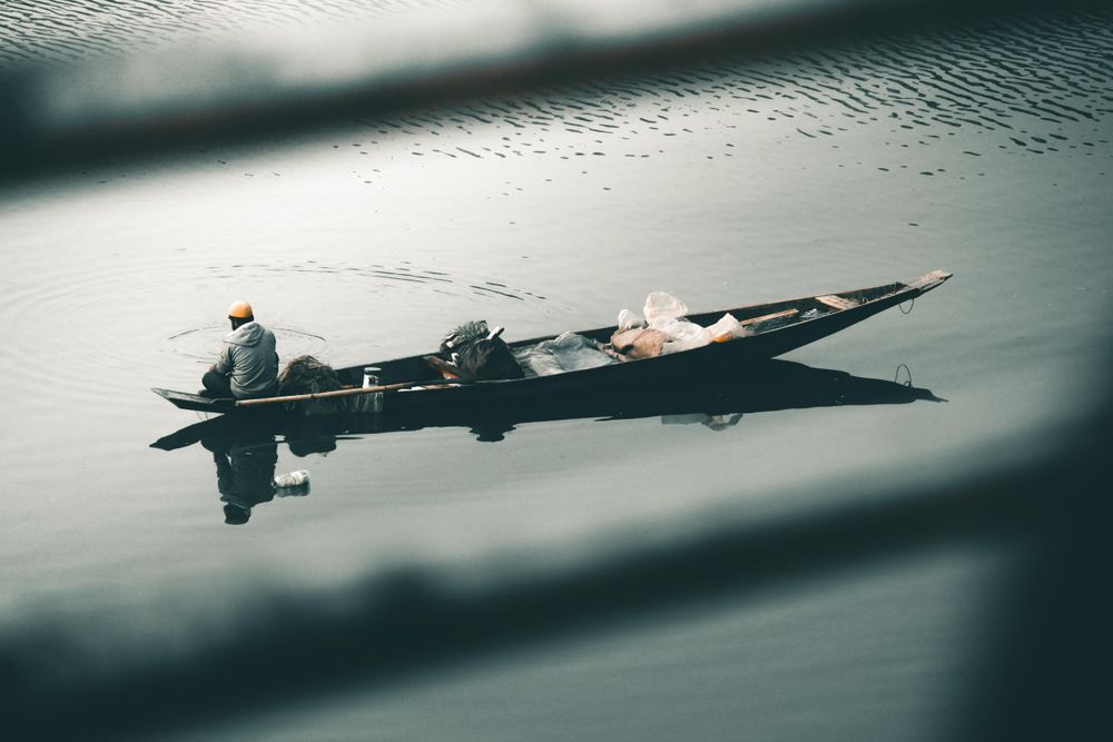 Man sitting on boat on water