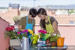 Two young people potting plants 0Pjzl7
