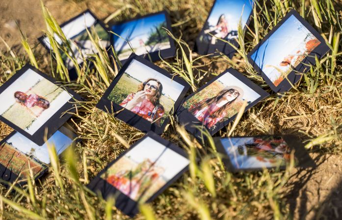 Bunch on instant pictures on grass