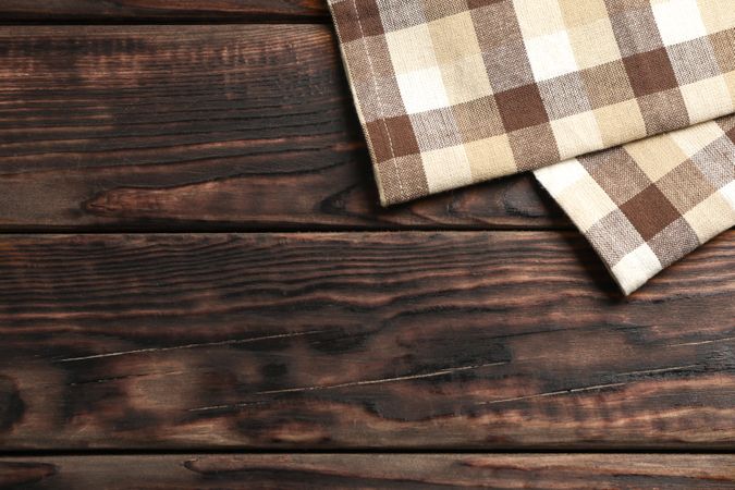 Fabric napkins on wooden background, space for text