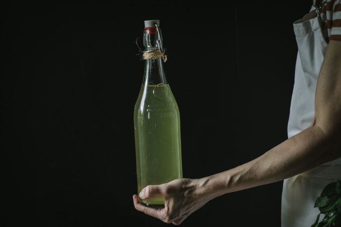 Female with bottle of elderflower syrup