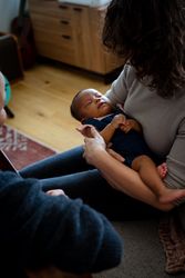Mother looking down while holding baby girl