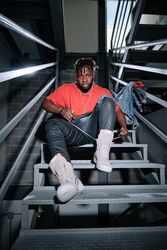 Stylish serious man sitting on stairs