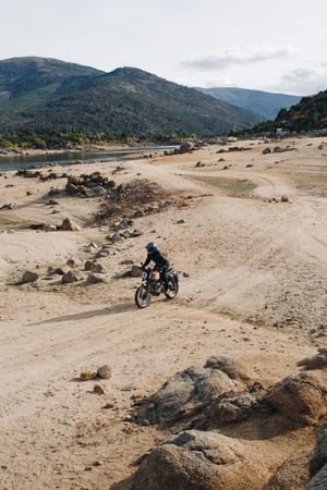 Motorcyclist on off-road track near river