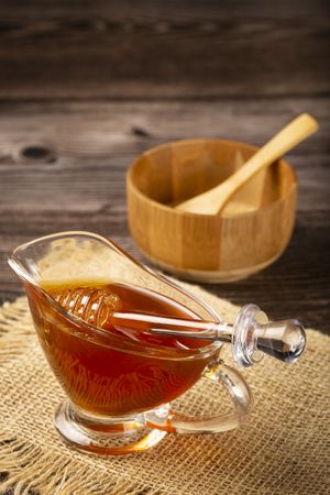 Honey in glass bowl on the table.