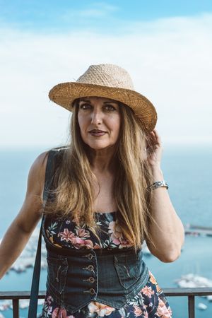 Stylish woman on terrace of seashore