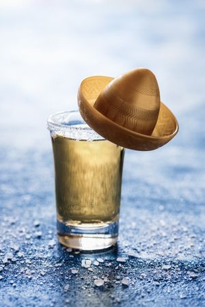 Gold tequila shot with a sombrero
