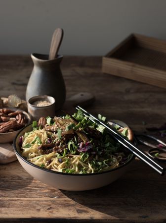 Miso noodles with egg plants and shiitake in bowl on table