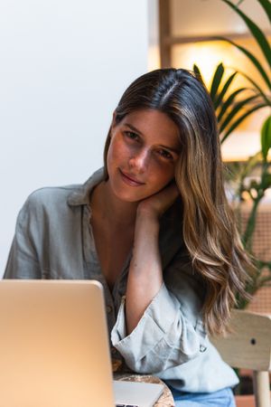 Woman surfing internet on laptop at cafe table