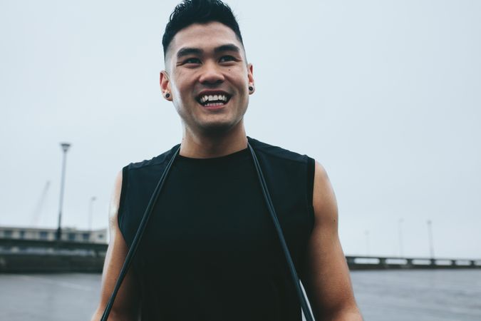 Smiling man in active wear standing outdoors