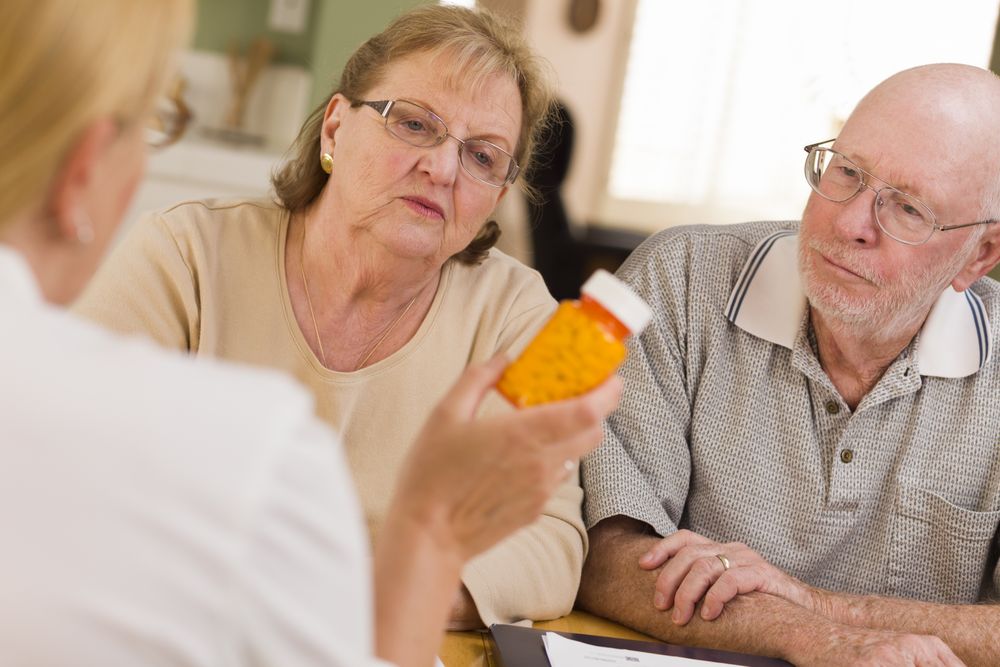 Doctor or Nurse Explaining Prescription Medicine to Older Couple