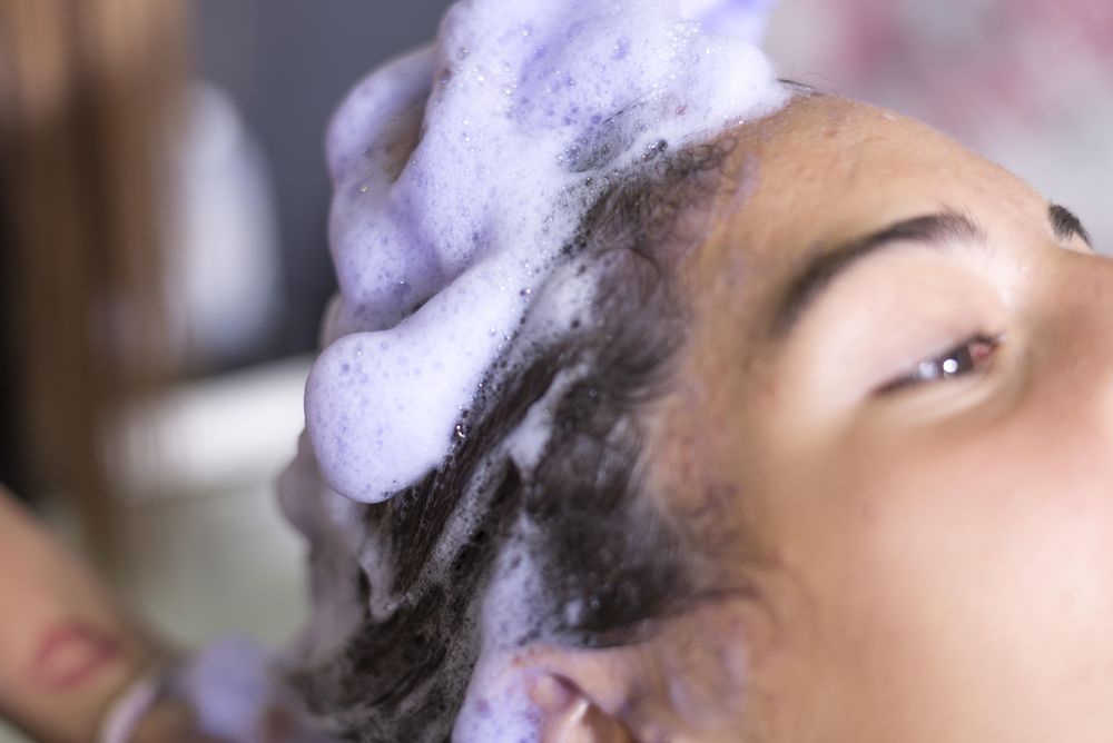 Close up of female’s head being washed in salon