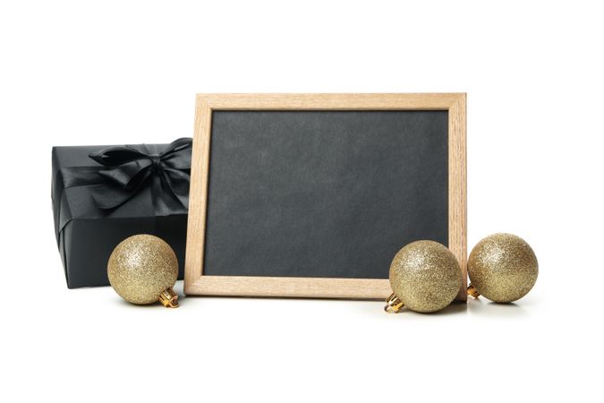 Gift box, baubles and chalkboard isolated on light background