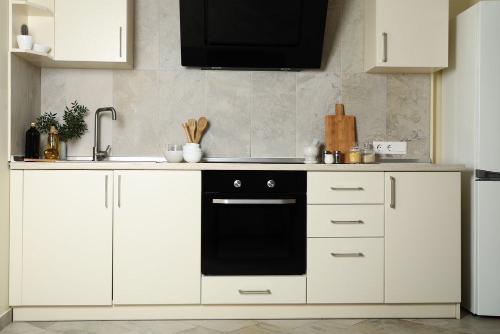 Modern kitchen interior with different supplies in light colors