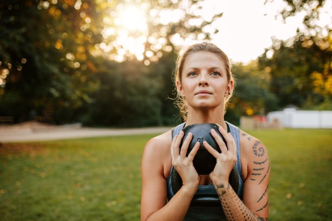 Portrait of fit young woman doing workout with kettlebell