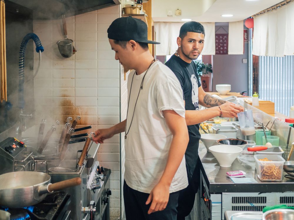 Multiethnic cooks working in kitchen of cafe