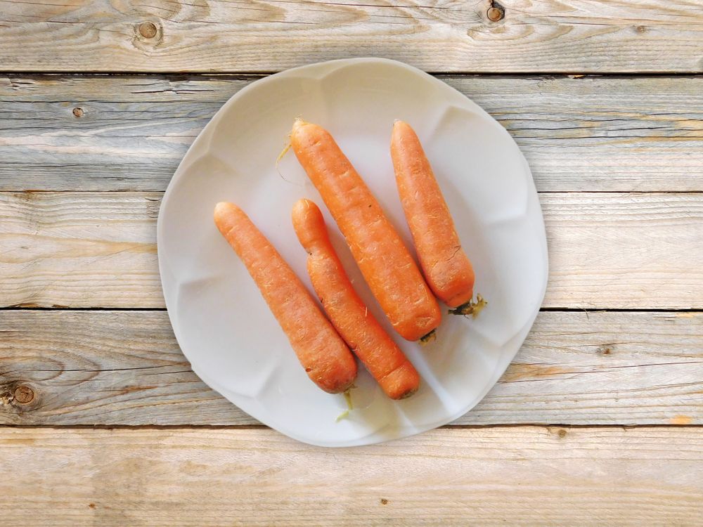 Carrots On The Wooden Background