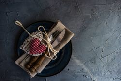 Top view of table setting with navy plate and heart ornaments