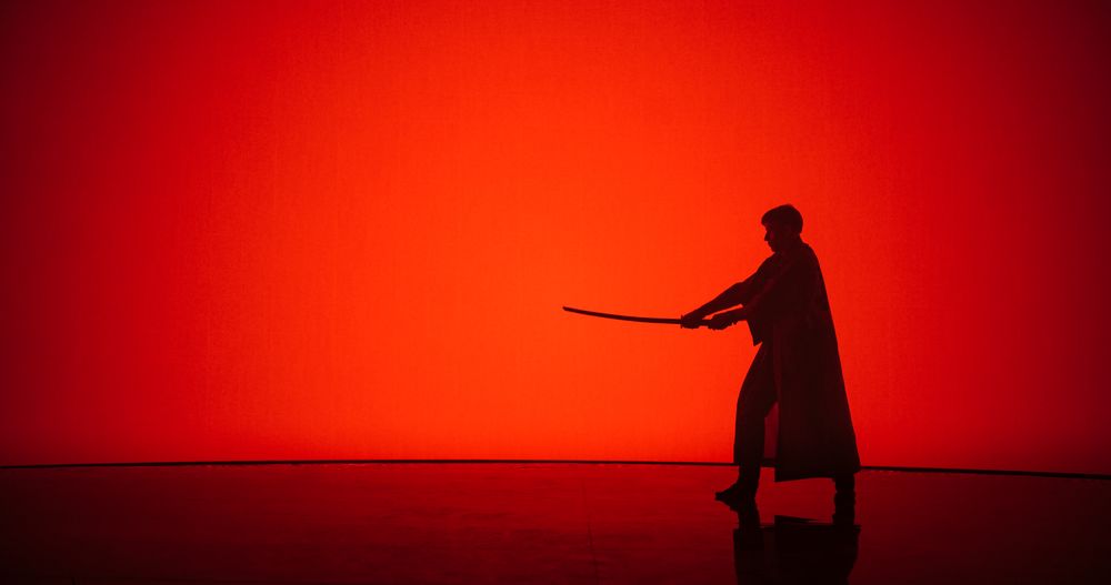 Athletic Man Practicing Kendo Martial Arts with a Katana or a Bamboo Sword.