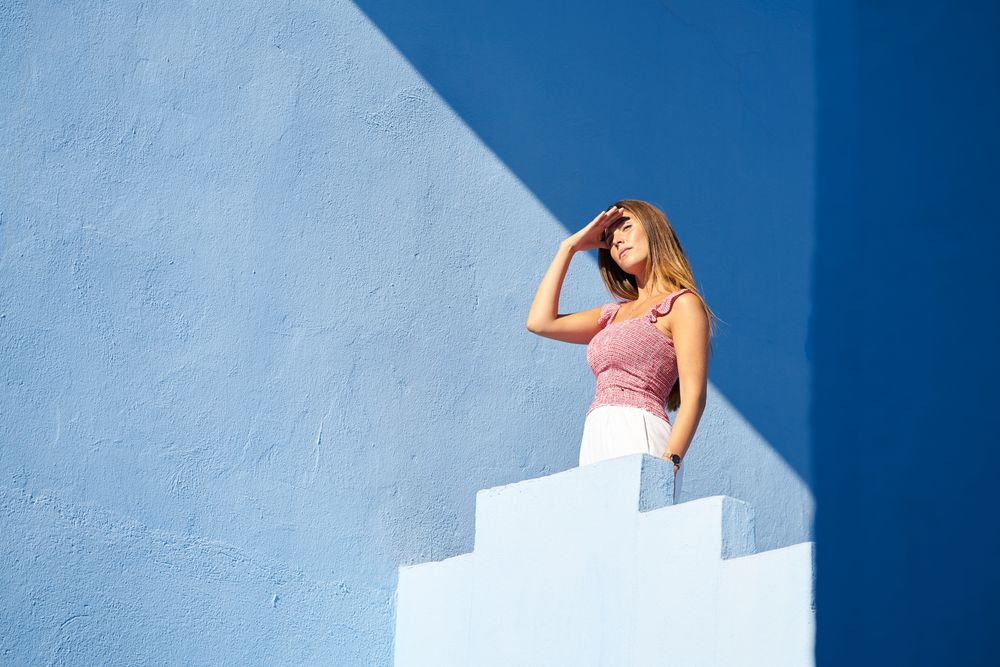Woman standing on the top of a blue building