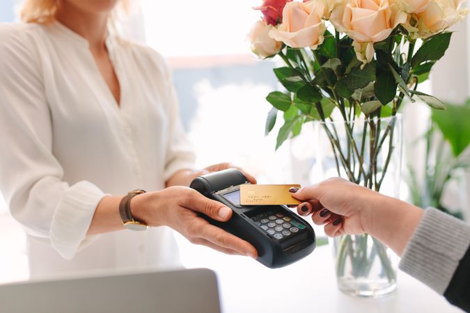 Customer paying with contactless card at florist
