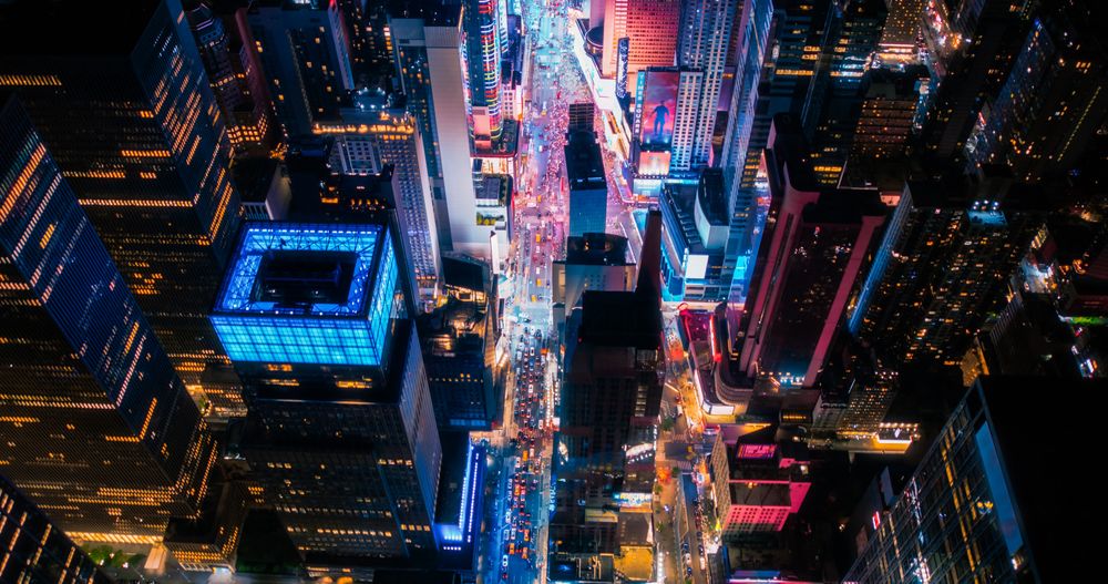 New York Concrete Jungle at Night. Aerial Photo from a Helicopter Tour Around Manhattan. Scenes with Modern Skyscraper Blocking the View on Crowded Times Square Area with Tourists