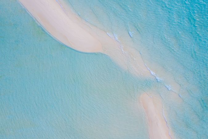 Waves coming up on sand dunes in tropical waters