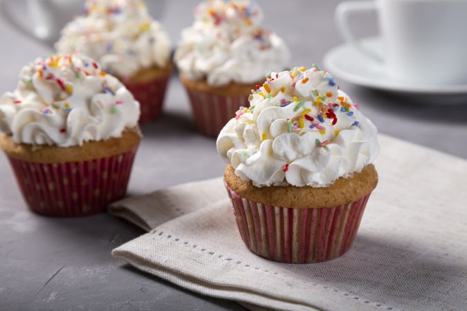 Tasty party cupcakes on the table. Cupcakes with whipped cream.