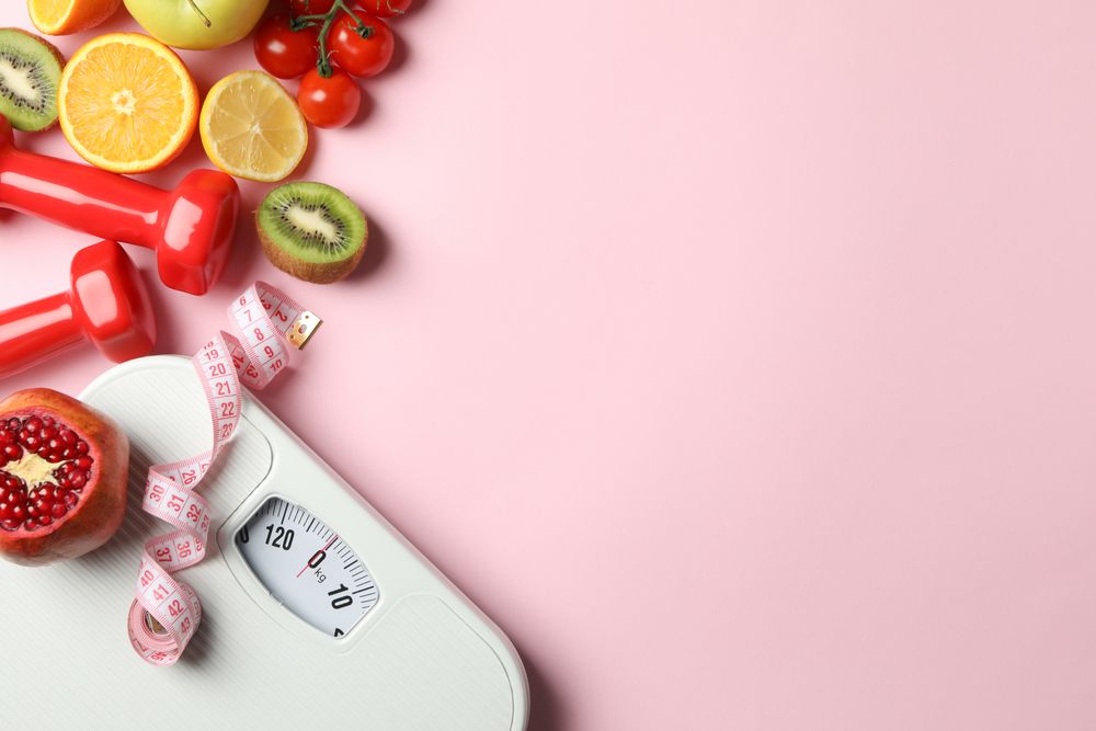 Weight loss or healthy lifestyle accessories on pink background