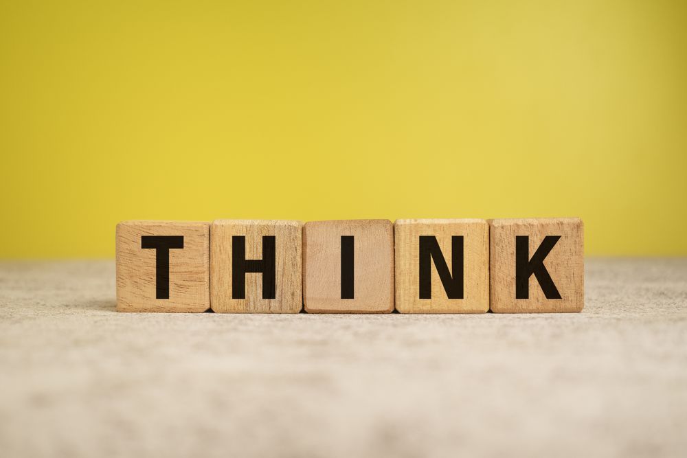 think word on wooden blocks on yellow background