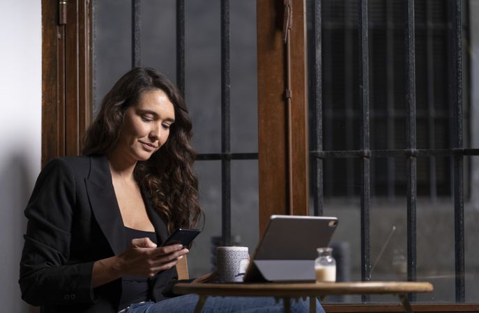Young female using a mobile phone in cafe