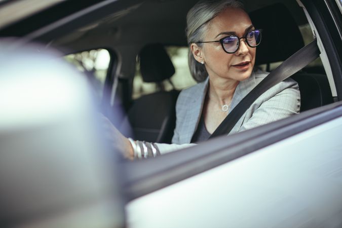 Mature woman driving a car in the city
