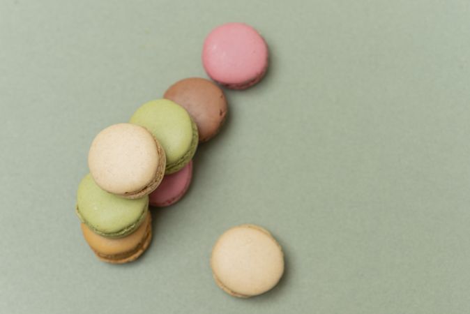 Top view of French pastel macaroons on a green background