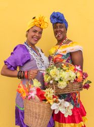 Havana, Cuba - November, 22 2012: Smiling Cuban women with flowers