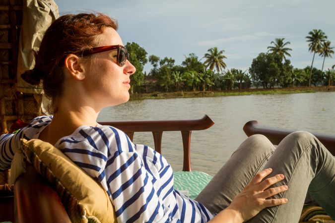 Woman relaxing on terrace near sea