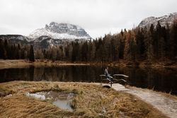 Woman delighting in views near lake and mountains