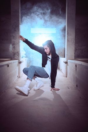Young man preparing performing candle movement of breakdance