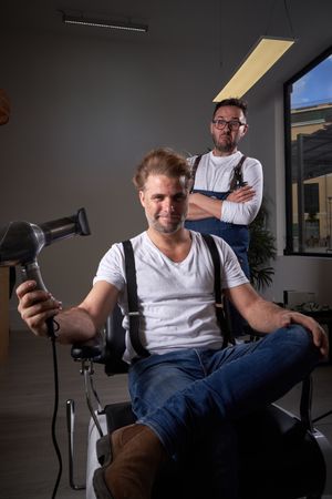 Brutal man drying hair in barbershop