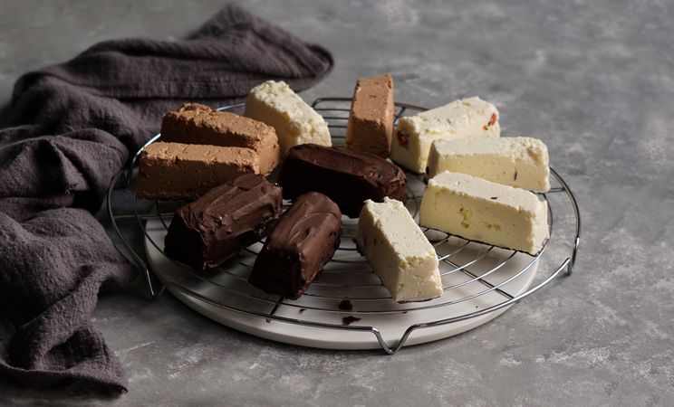 Chocolate and strawberry cakes near bows with ingredients