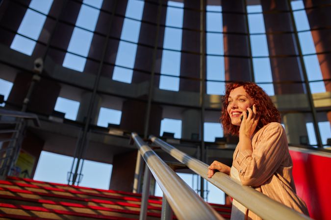 young female communicating via smartphone at station