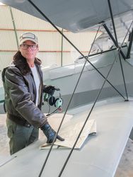 Pilot with map beside small plane