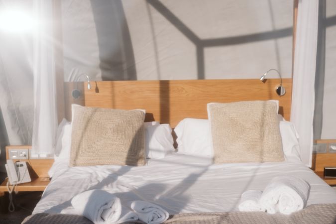 Sunlit comfortable bed in hotel