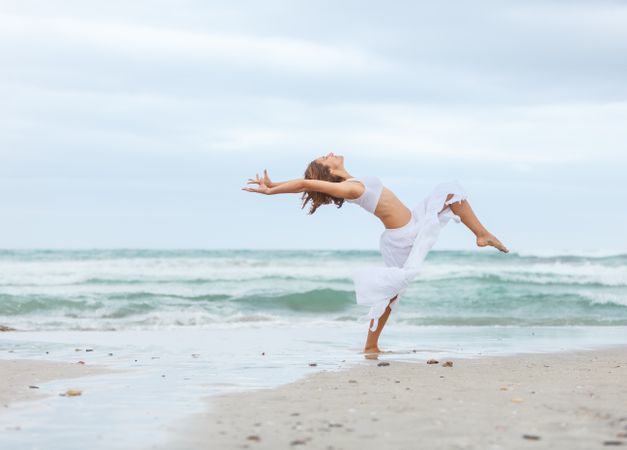 woman dancing near sea