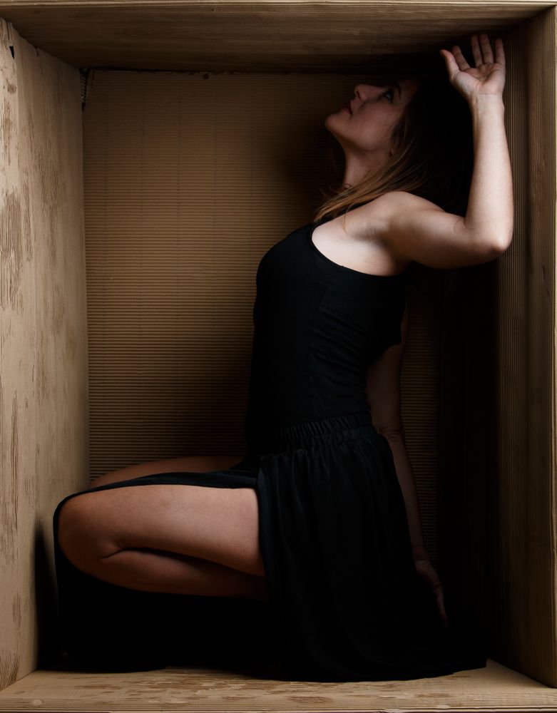 woman sitting in carton box