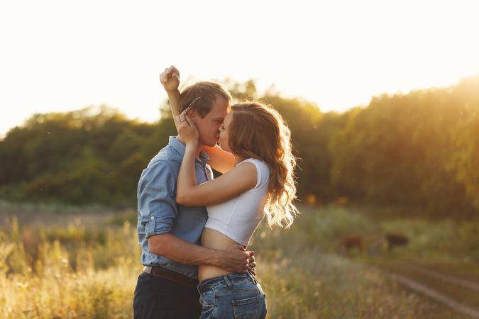 Happy couple kissing at sunset