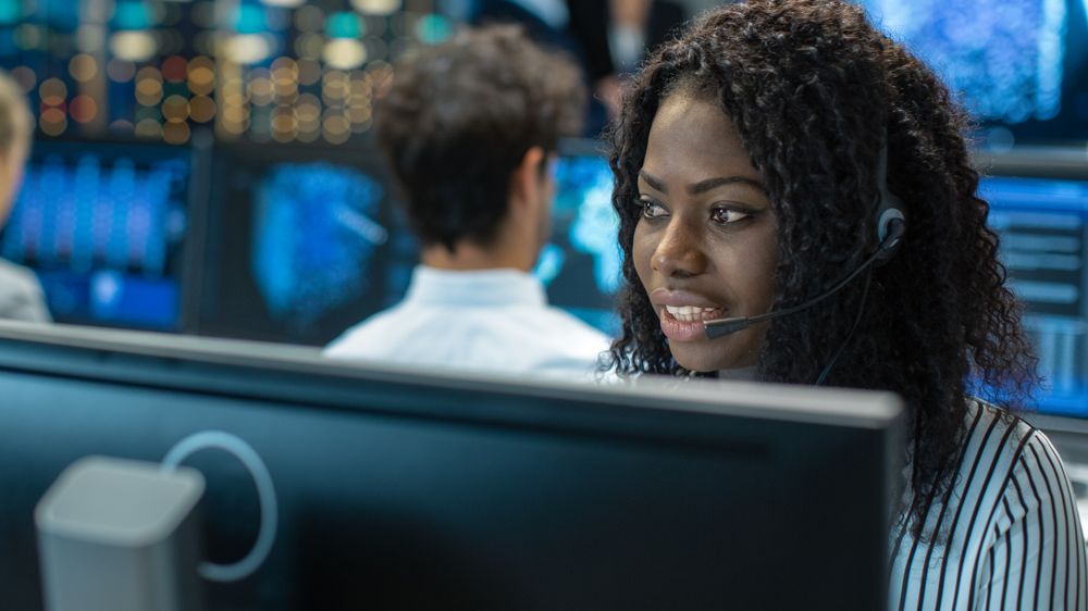 Female Customer Service Representative Answer Client's Questions in a Headset.