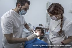 Dentist examining little boy's teeth in clinic 41znpb